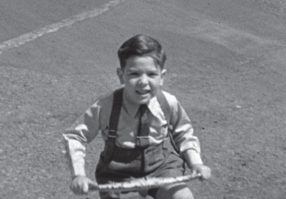 “This guy is getting too tough for us . . .” A young Cohen on his tricycle, circa 1938.