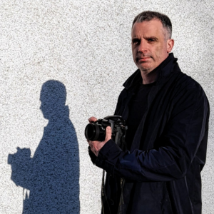 author photo of duncan simpson holding a camera